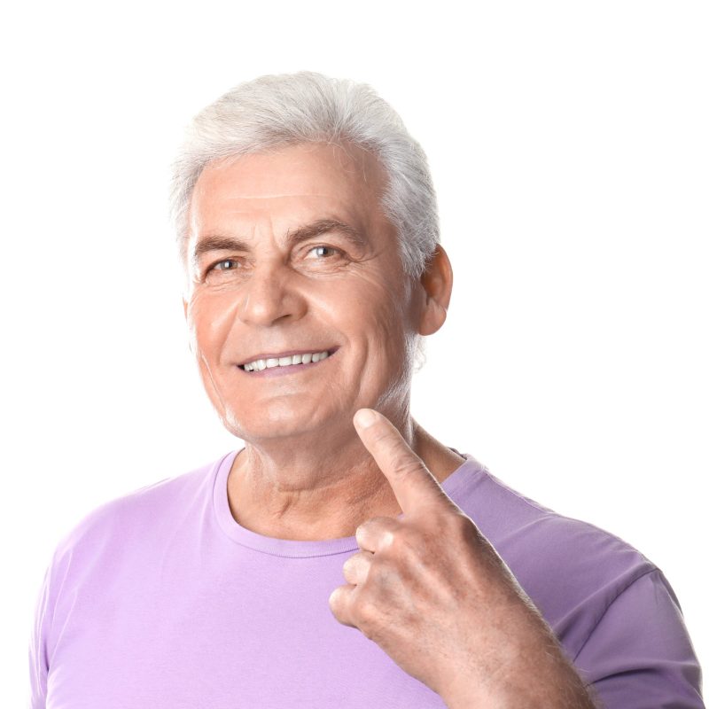 Mature man with healthy teeth on white background